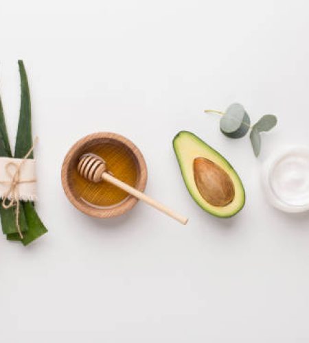 Medical plants used in alternative cosmetology: aloe, honey, coconut and avocado, white background, panorama